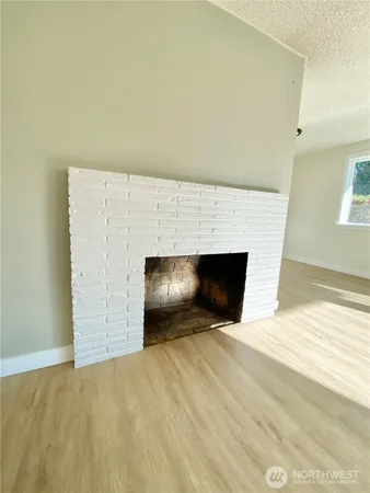 a view of an empty room with a fireplace