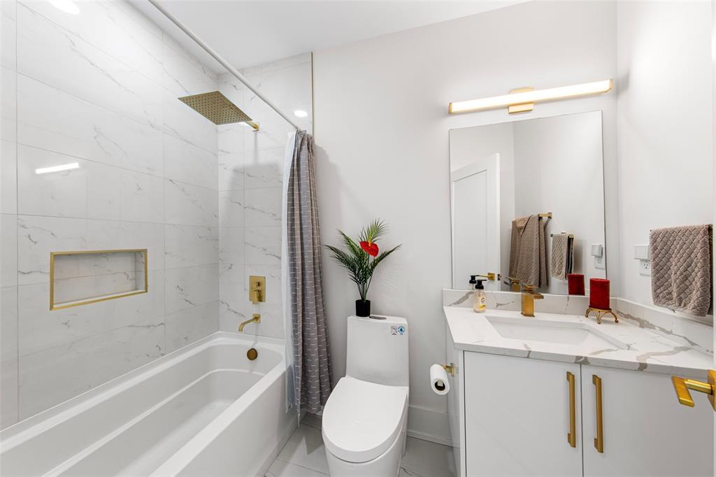 2187 Main Street Sarasota, FL 34237 - Photo 11 of 46 a bathroom with a granite countertop sink toilet and shower