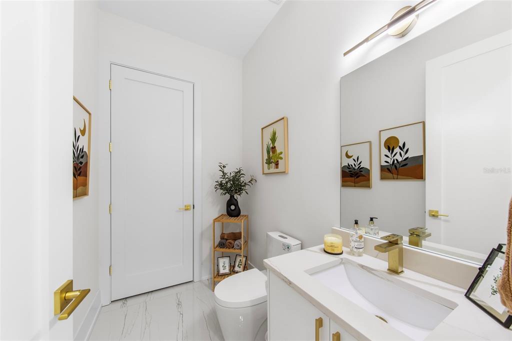 2187 Main Street Sarasota, FL 34237 - Photo 13 of 46 a bathroom with a toilet sink and mirror