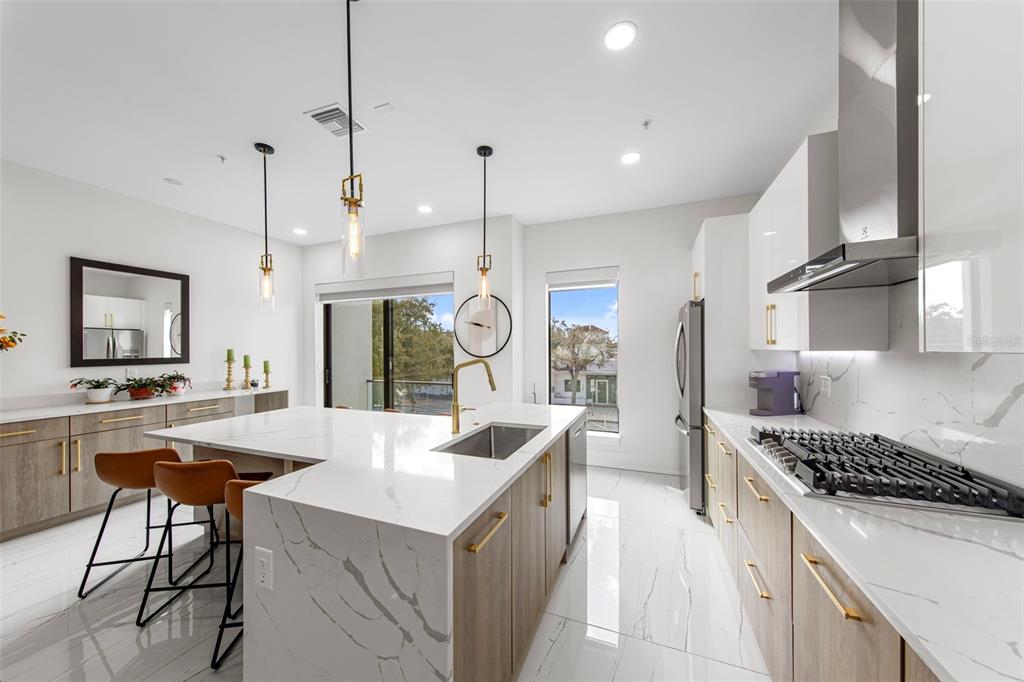 2187 Main Street Sarasota, FL 34237 - Photo 16 of 46 a kitchen with stainless steel appliances kitchen island a large island in the center