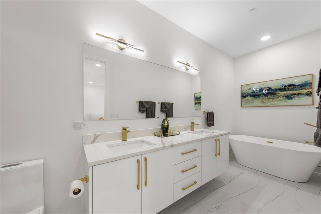 2187 Main Street Sarasota, FL 34237 - Photo 32 of 46 a bathroom with a double vanity sink a mirror and a bathtub