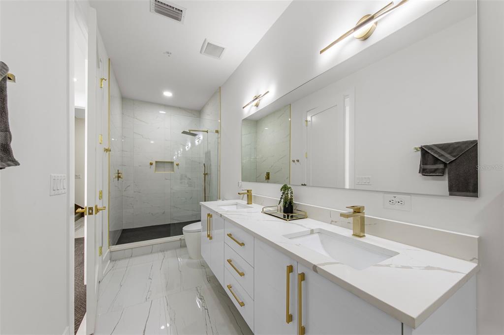 2187 Main Street Sarasota, FL 34237 - Photo 33 of 46 a bathroom with a sink a toilet a mirror and shower