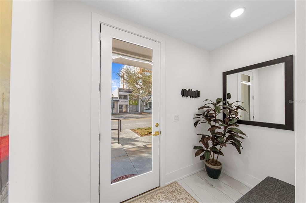 2187 Main Street Sarasota, FL 34237 - Photo 6 of 46 a view of a hallway with wooden floor and a potted plant
