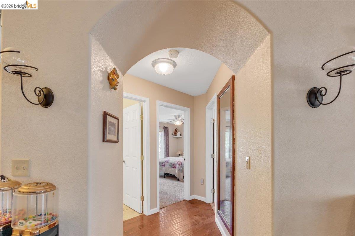 14450 Jacksonville Road Jamestown, CA 95327 - Photo 32 of 85 Archway entry with textured walls, wood-finish flooring, and flush mount lighting