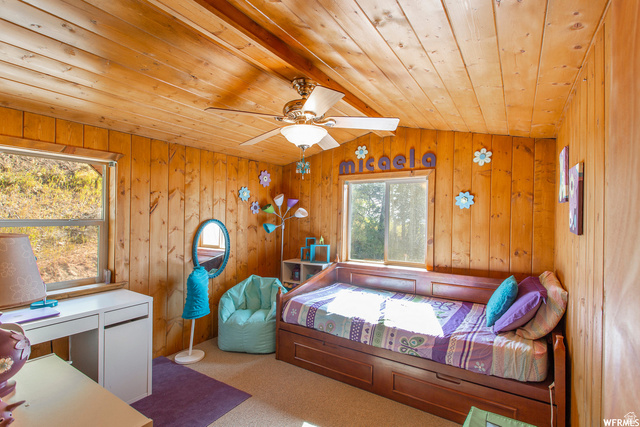 1644 West Tollgate Cyn Road, Unit 79AM Coalville, UT 84017 - Photo 16 of 31 Wood-paneled walls and ceiling, two windows, carpet flooring, and a ceiling fan with integrated lighting
