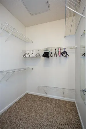 a view of storage and utility room with racks on the wall