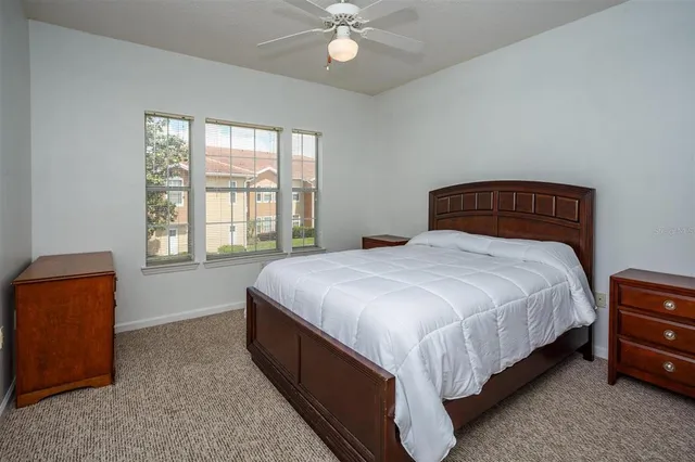 a bed sitting in a bedroom next to a window