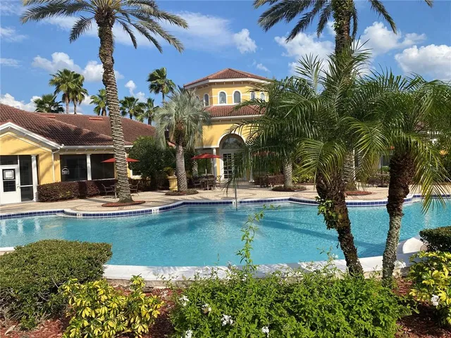 a view of a house with swimming pool and porch with furniture