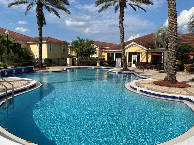 a view of a house with swimming pool yard and patio