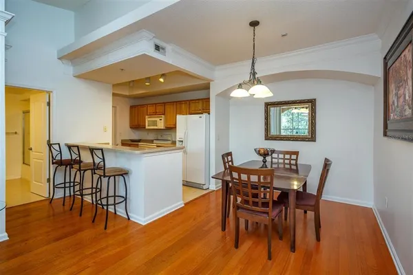 a dining room with furniture and wooden floor