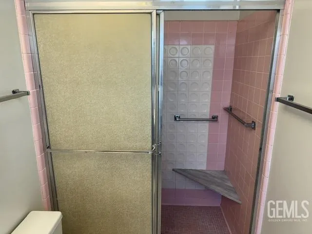 a bathroom with a glass shower door