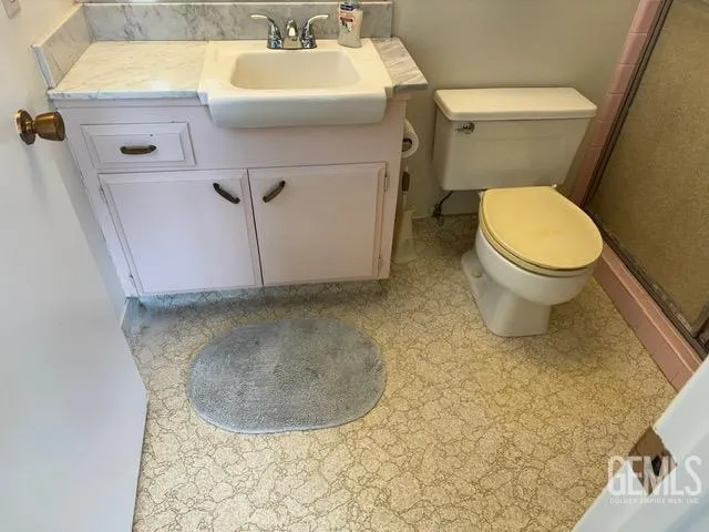 a bathroom with a sink toilet and a mirror