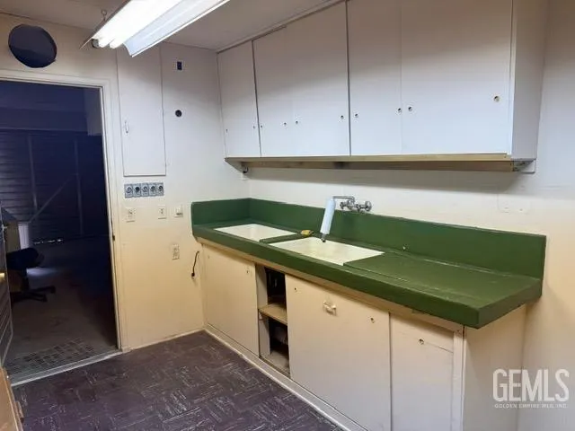 a kitchen with a sink and cabinets
