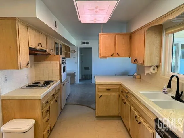 a kitchen with a sink stove and refrigerator