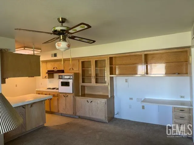 a kitchen that has a lot of cabinets in it and appliances