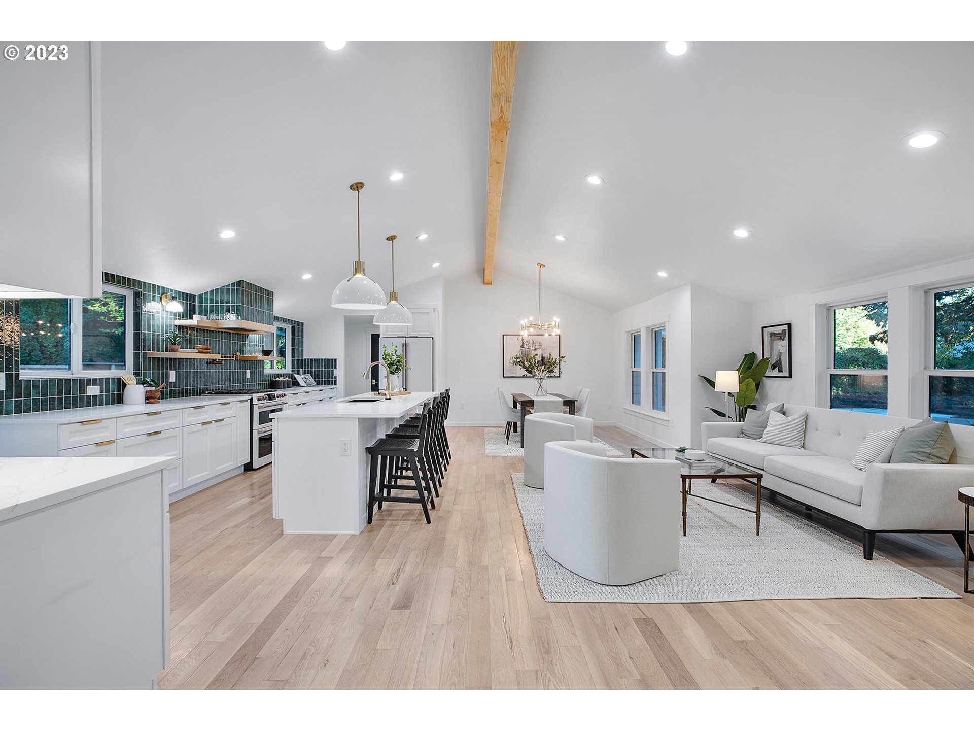 9906 Northwest Leahy Road Portland, OR 97229 - Photo 12 of 36 a living room with furniture a wooden floor and kitchen view