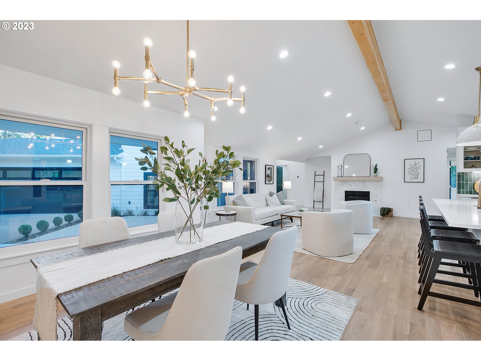 9906 Northwest Leahy Road Portland, OR 97229 - Photo 18 of 36 a dining room with kitchen island furniture a chandelier and kitchen view
