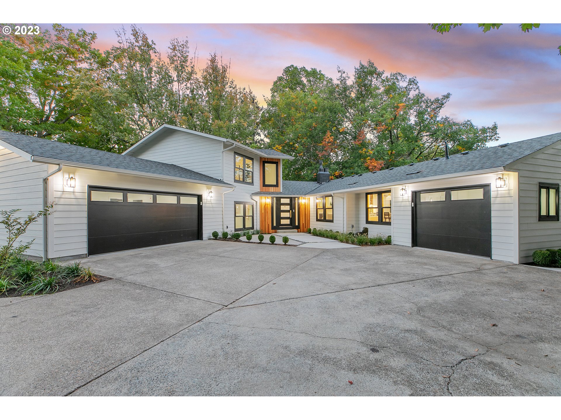 9906 Northwest Leahy Road Portland, OR 97229 - Photo 2 of 36 a front view of a house with a yard and garage