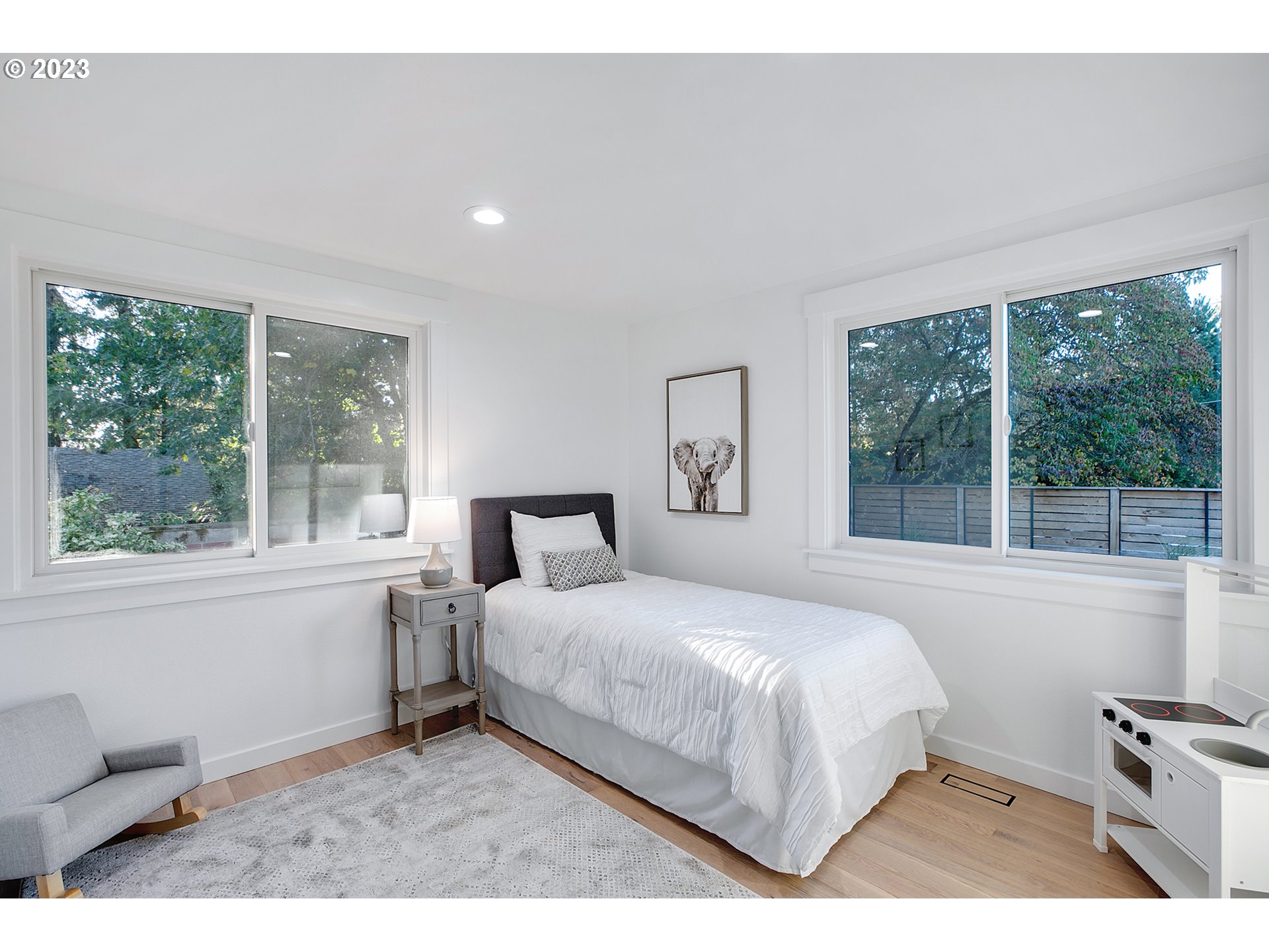9906 Northwest Leahy Road Portland, OR 97229 - Photo 21 of 36 a bedroom with a bed and a large window