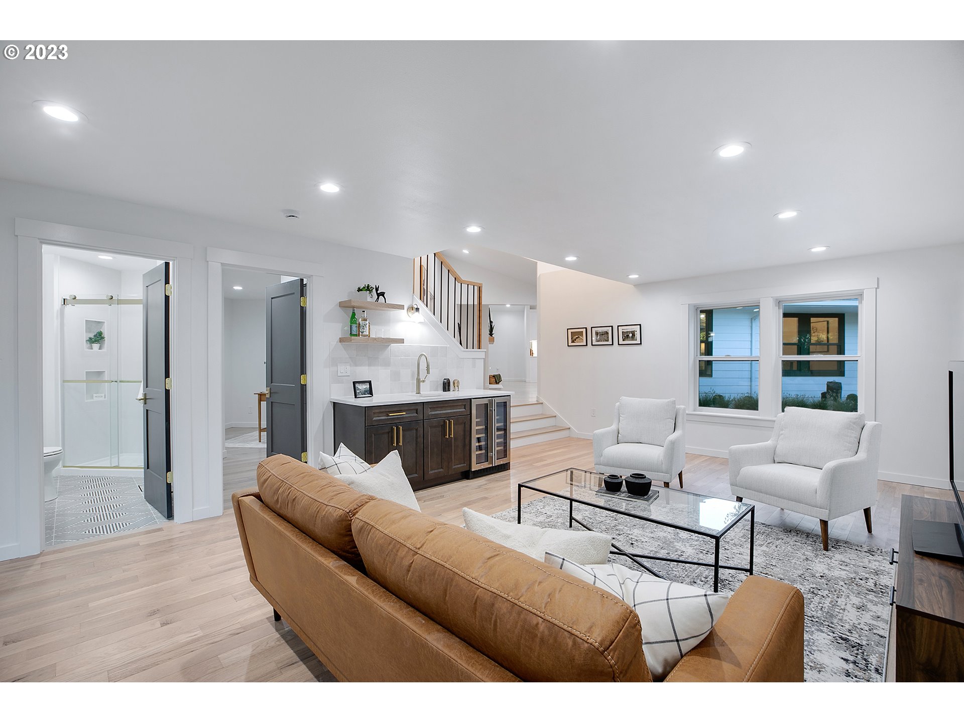 9906 Northwest Leahy Road Portland, OR 97229 - Photo 26 of 36 a living room with furniture white walls and a view of kitchen
