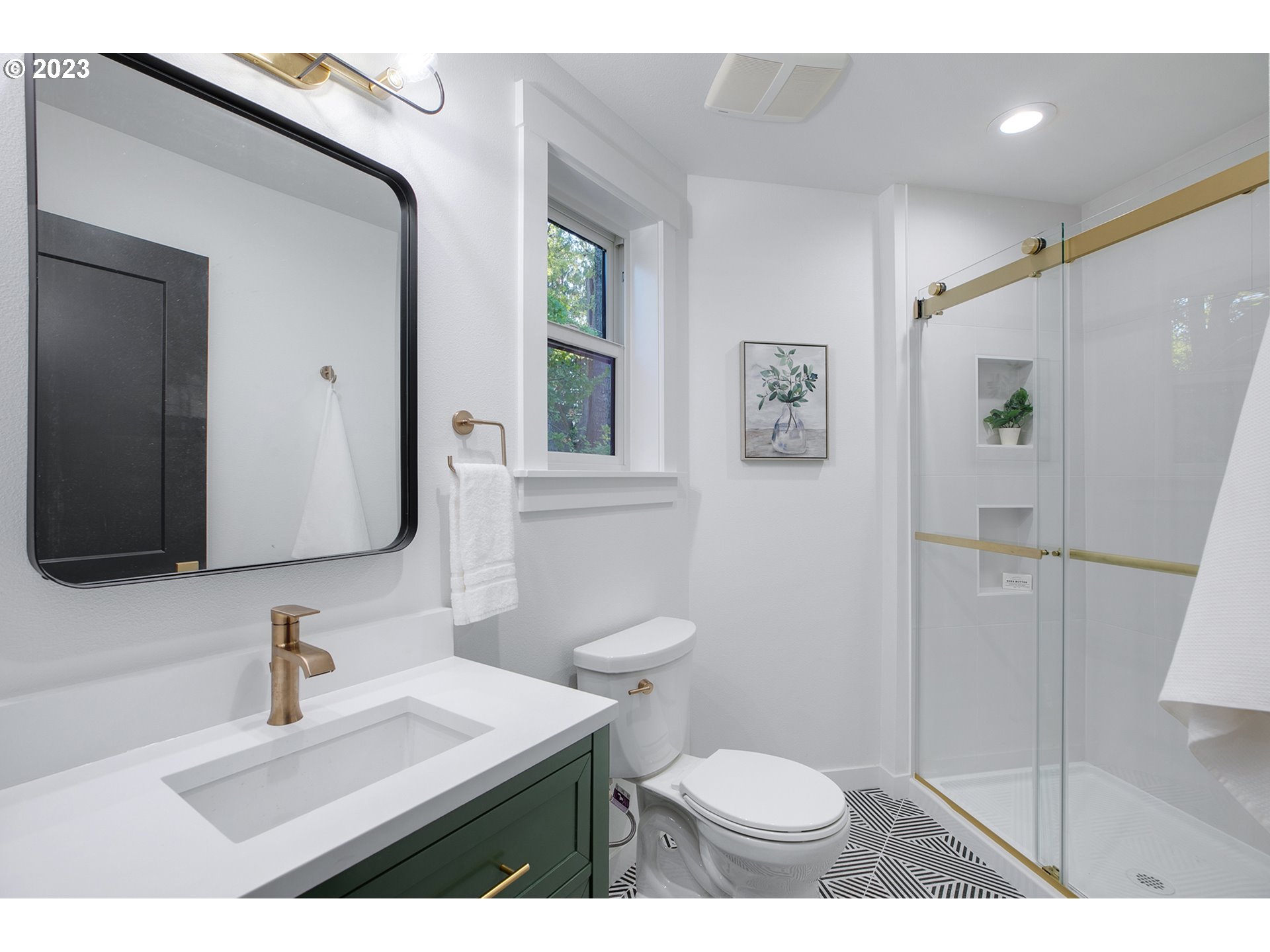 9906 Northwest Leahy Road Portland, OR 97229 - Photo 28 of 36 a bathroom with a sink a toilet a mirror and shower