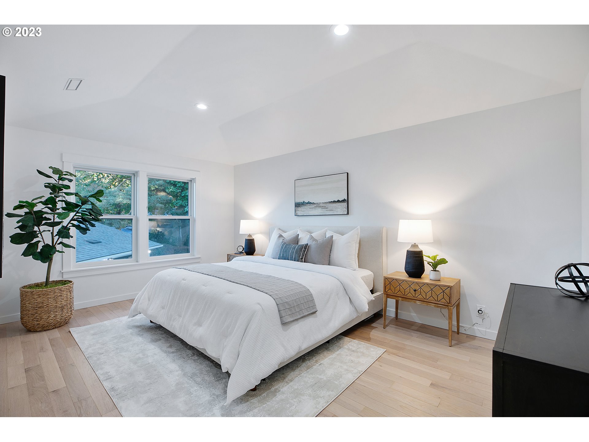 9906 Northwest Leahy Road Portland, OR 97229 - Photo 30 of 36 a bedroom with a large bed and a potted plant