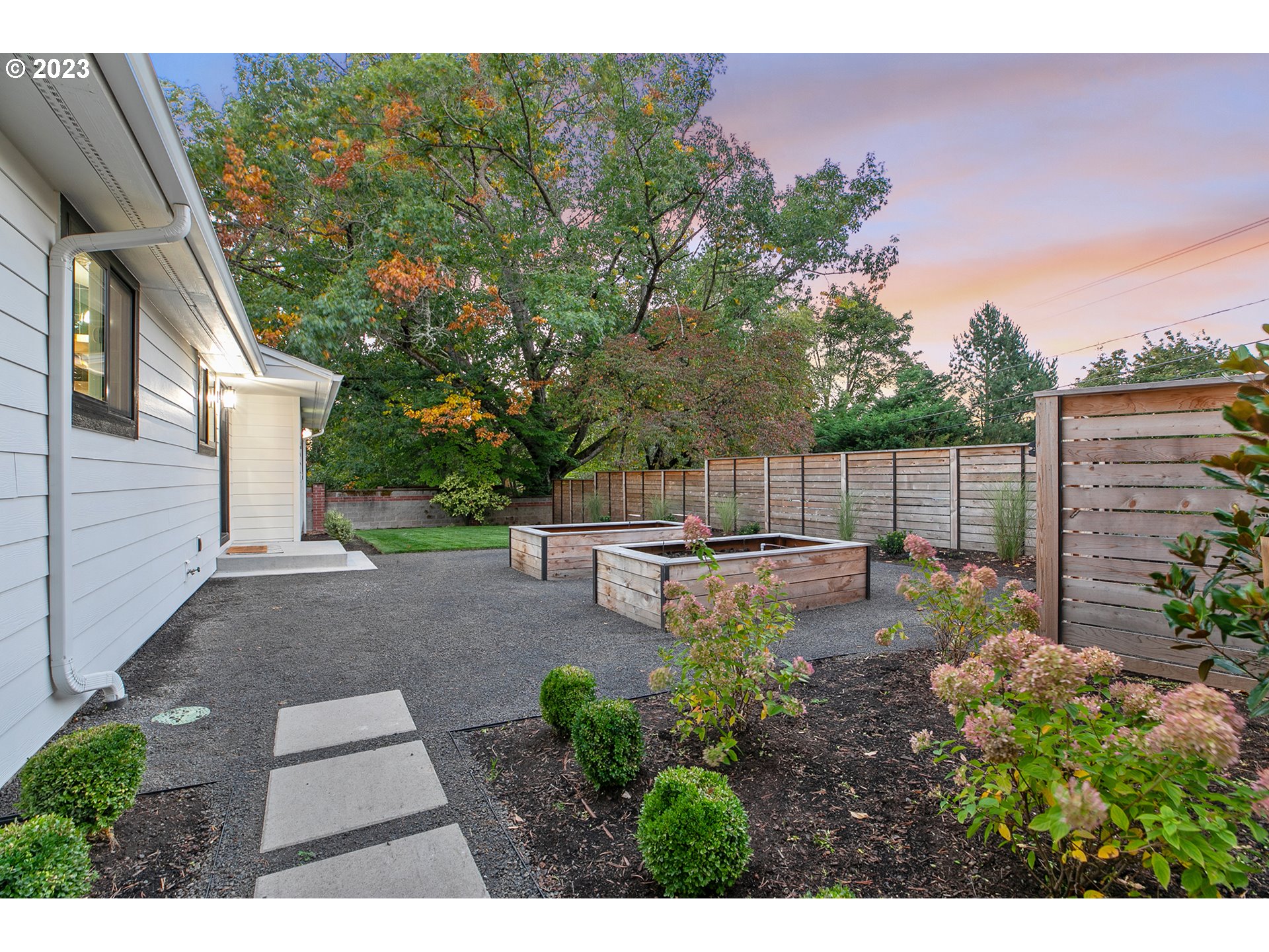 9906 Northwest Leahy Road Portland, OR 97229 - Photo 9 of 36 a backyard of a house with table and chairs