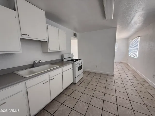a kitchen with a sink and cabinets