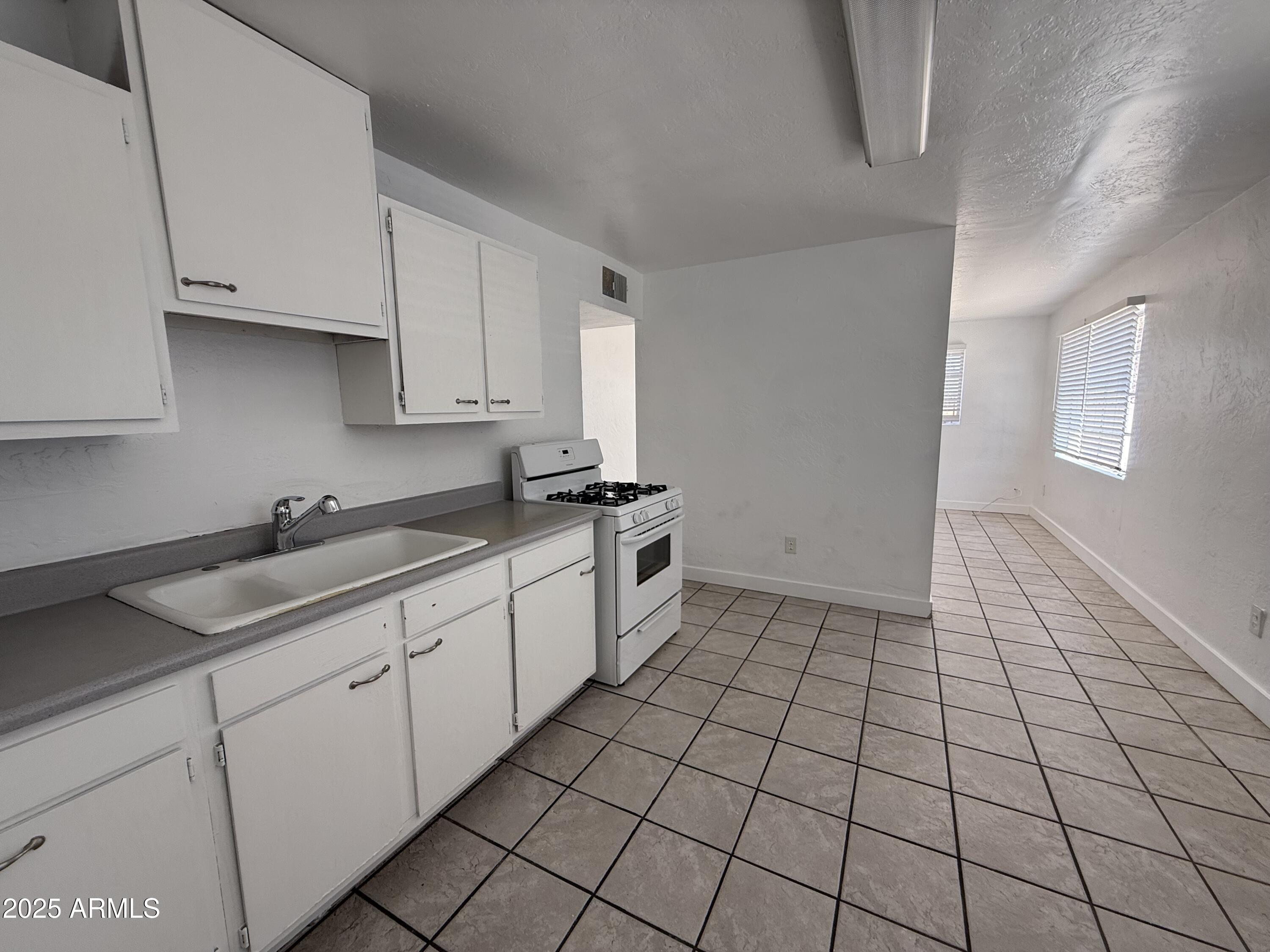 7532 North 21st Avenue, Unit 1 Phoenix, AZ 85021 - Photo 11 of 19 a kitchen with a sink and cabinets