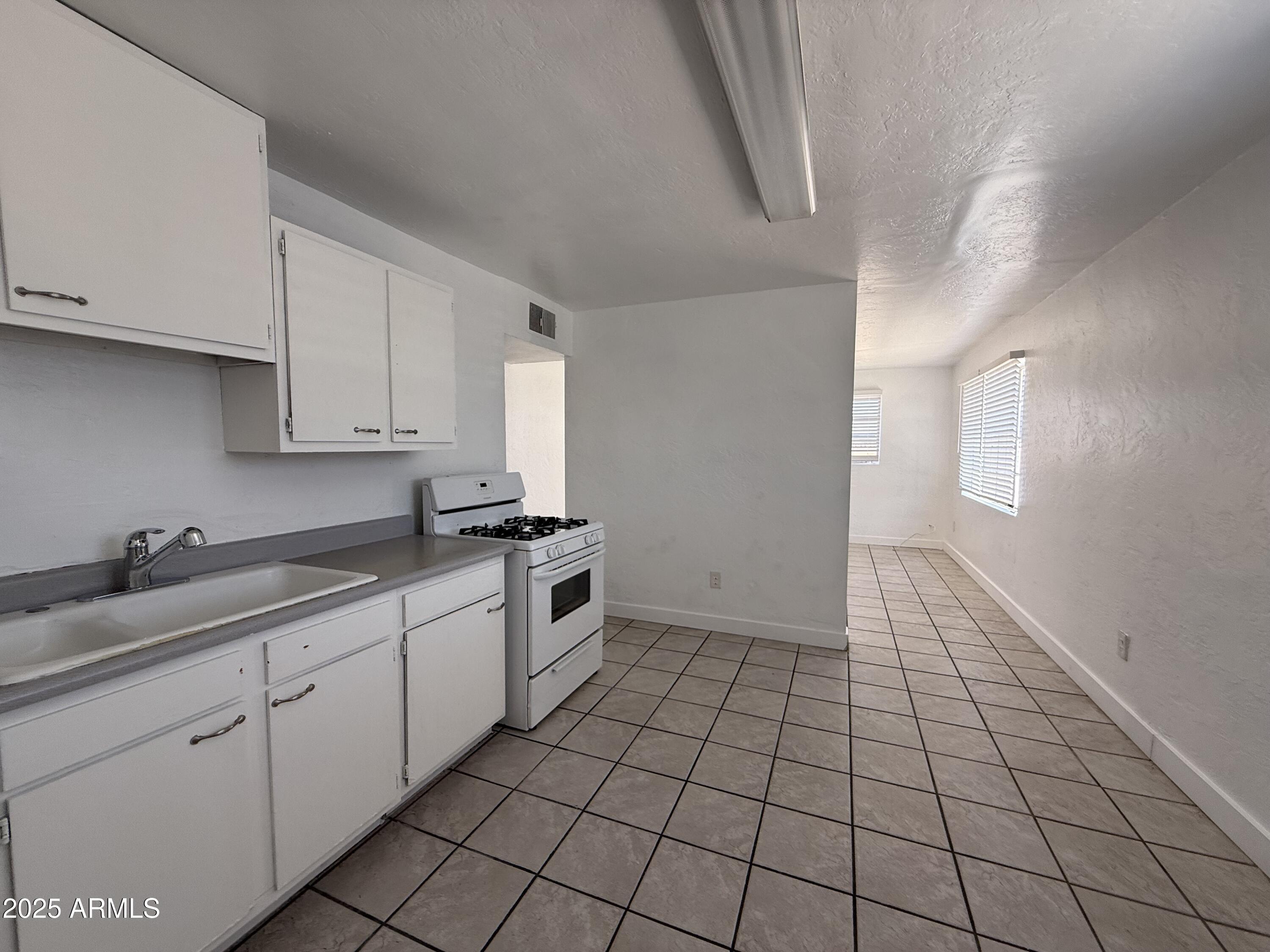 7532 North 21st Avenue, Unit 1 Phoenix, AZ 85021 - Photo 13 of 19 a kitchen with a sink and cabinets