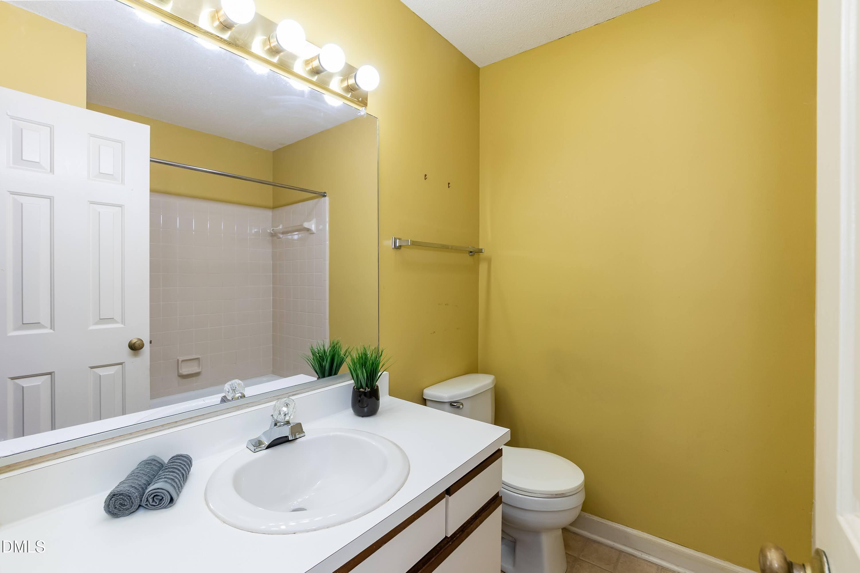 5604 Spring Pines Way Raleigh, NC 27616 - Photo 14 of 22 a bathroom with a sink and a mirror