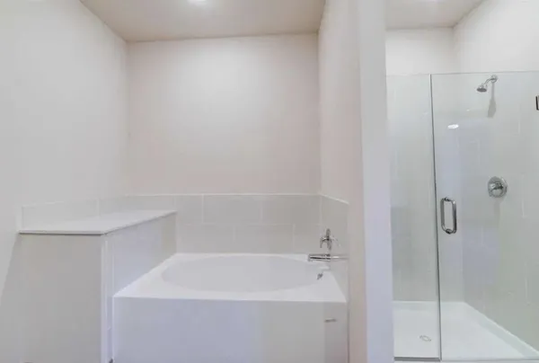 an empty room with wooden floor cabinet and windows