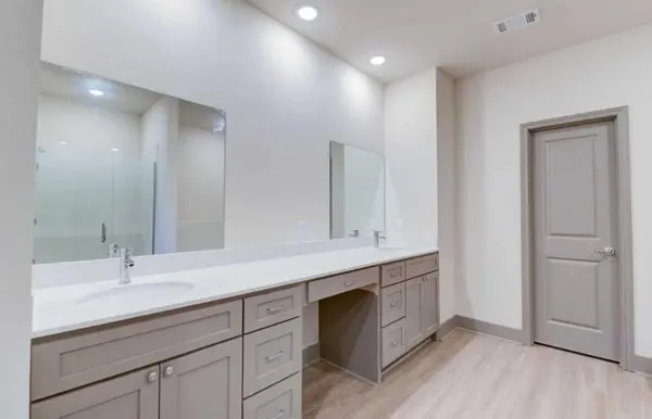 a bathroom with a double vanity sink and a mirror