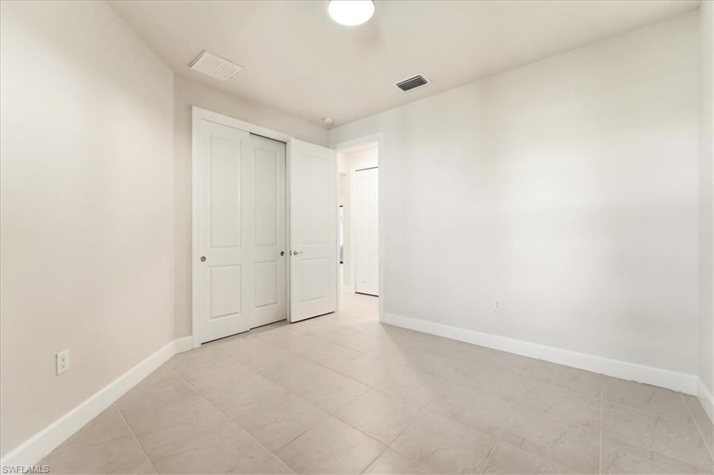 5935 Mayflower Way Ave Maria, FL 34142 - Photo 14 of 36 an empty room with an entryway