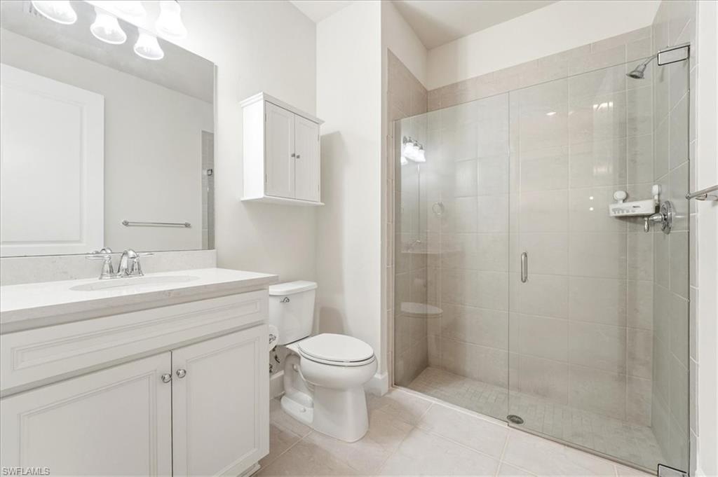 5935 Mayflower Way Ave Maria, FL 34142 - Photo 16 of 36 a bathroom with a sink a toilet and shower