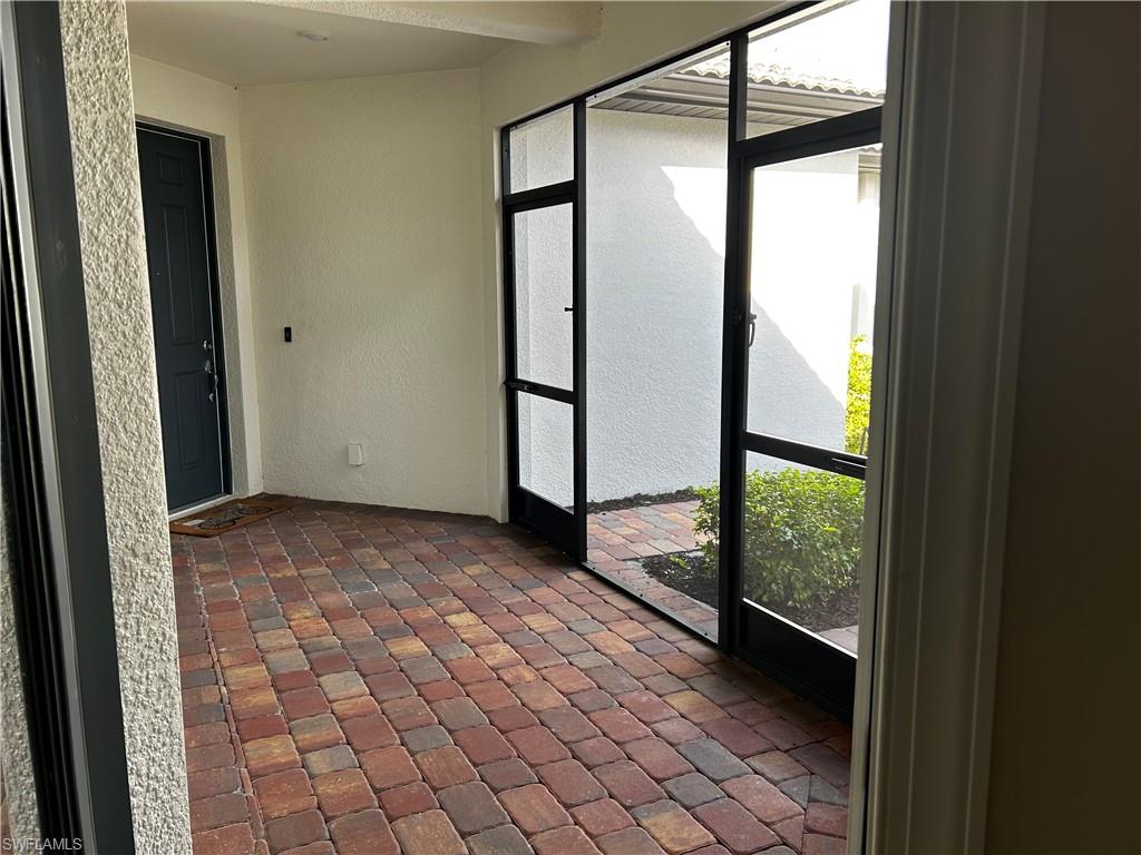 5935 Mayflower Way Ave Maria, FL 34142 - Photo 17 of 18 a view of a glass door with a glass door