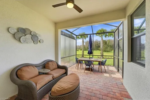 a dining room with furniture and a floor to ceiling window
