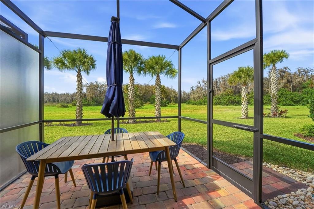 5935 Mayflower Way Ave Maria, FL 34142 - Photo 19 of 36 a view of a porch with furniture and yard