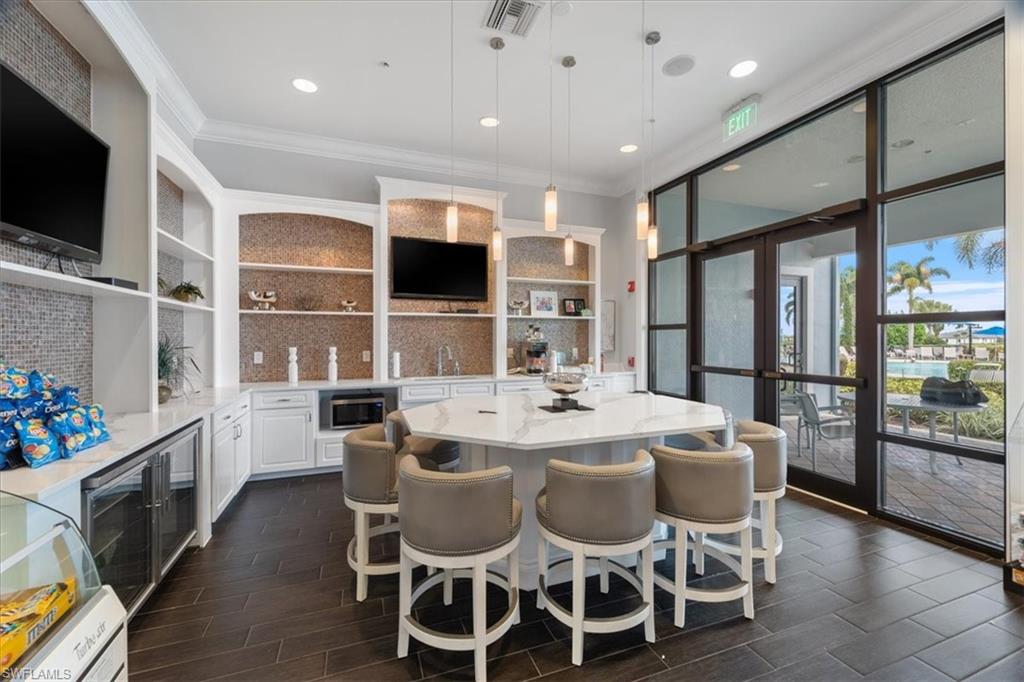 5935 Mayflower Way Ave Maria, FL 34142 - Photo 30 of 36 a large kitchen with a table and chairs