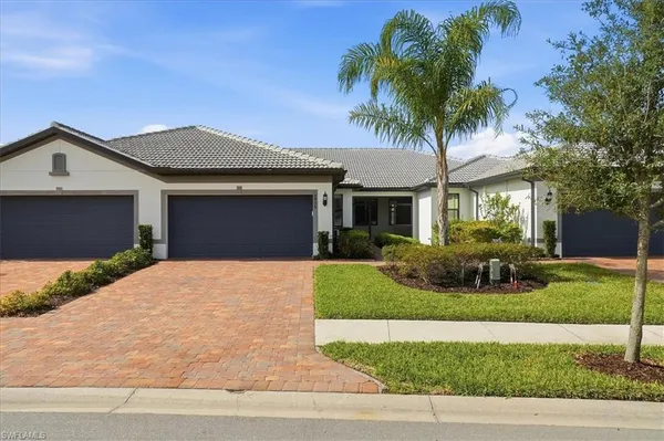 a front view of a house with a yard and garage