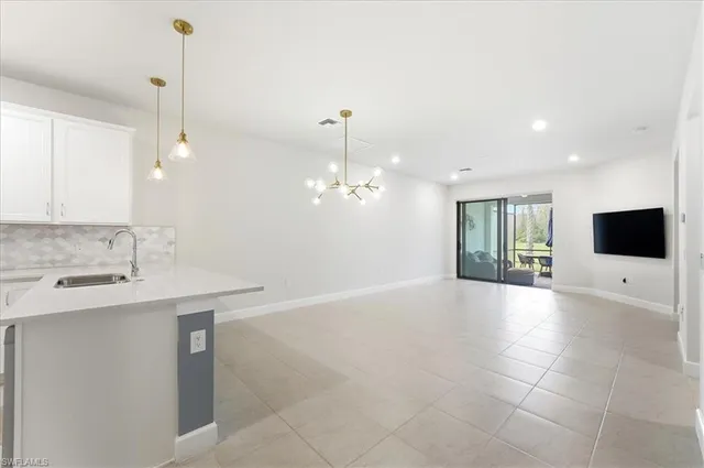 a view of a kitchen with a sink and a fireplace