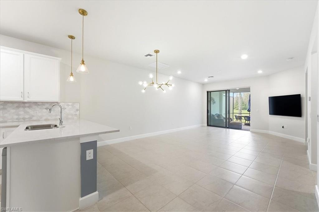 5935 Mayflower Way Ave Maria, FL 34142 - Photo 7 of 36 a view of a kitchen with a sink and a fireplace