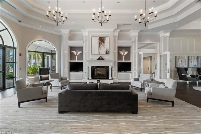 a living room with furniture fireplace and large windows