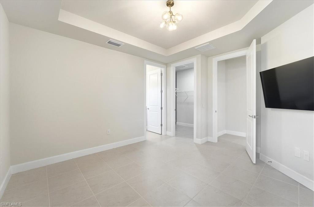 5935 Mayflower Way Ave Maria, FL 34142 - Photo 10 of 36 an empty room with chandelier fan