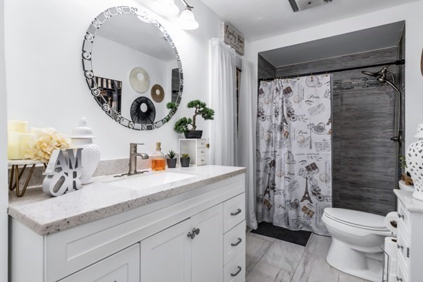 11 Cambridge Street Lawrence, MA 01843 - Photo 17 of 40 a bathroom with a sink mirror vanity and toilet