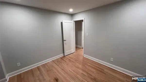 a view of hallway with wooden floor