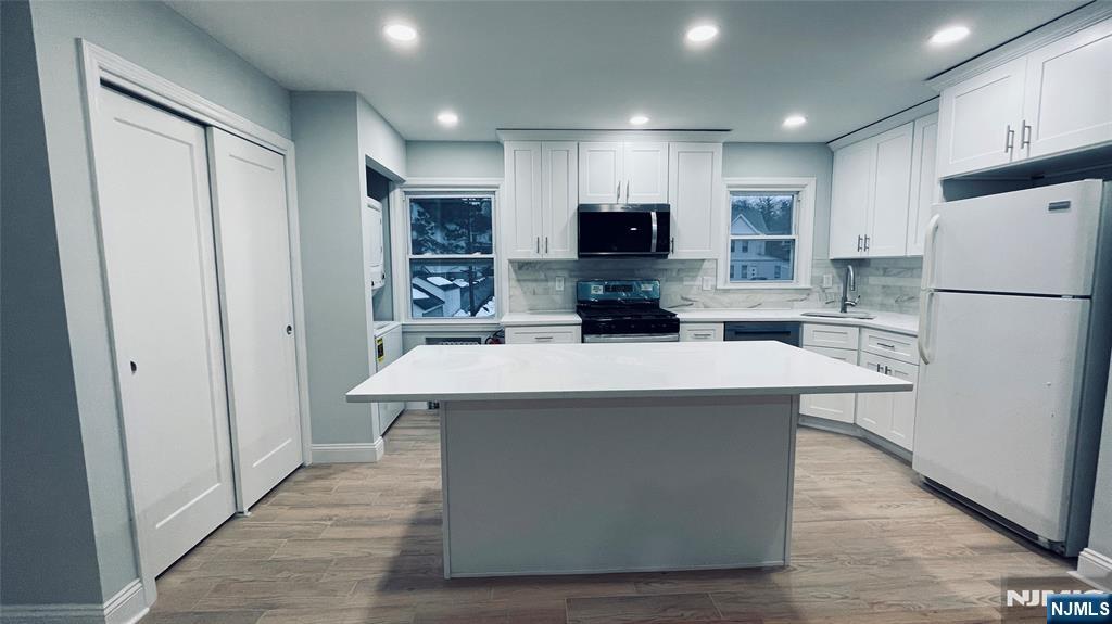 86 North Walnut Street Ridgewood, NJ 07450 - Photo 5 of 17 a kitchen with stainless steel appliances a refrigerator and a stove top oven