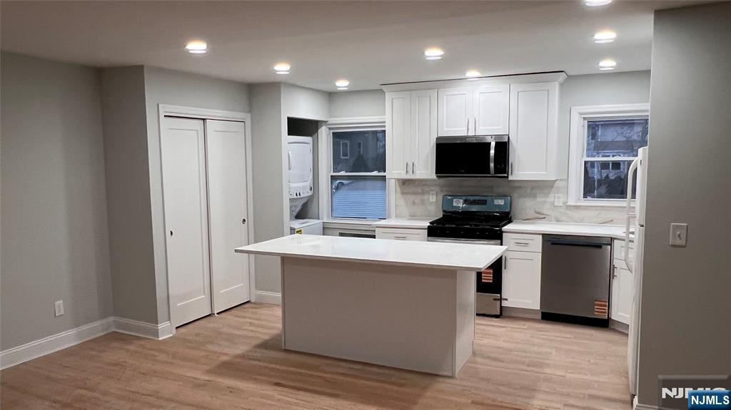 86 North Walnut Street Ridgewood, NJ 07450 - Photo 8 of 17 a kitchen with stainless steel appliances a stove top oven a sink a refrigerator and a microwave