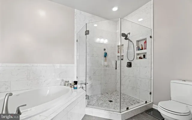 a bathroom with a bathtub and a shower