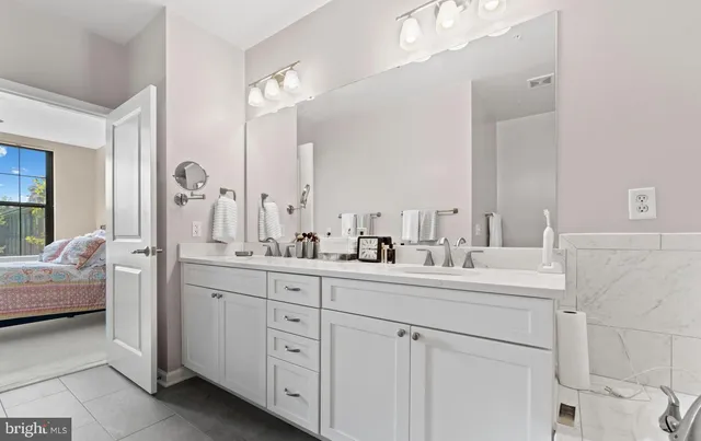 a bathroom with a double vanity sink mirror and